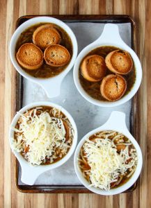 Topping bowls of soup with toasted bread and cheese.