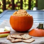 A tiny pumpkin filled with hummus