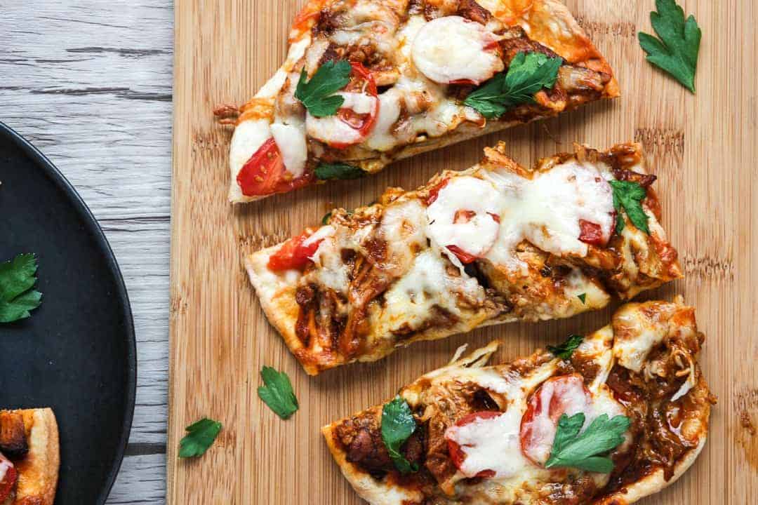 A pizza sitting on top of a wooden cutting board