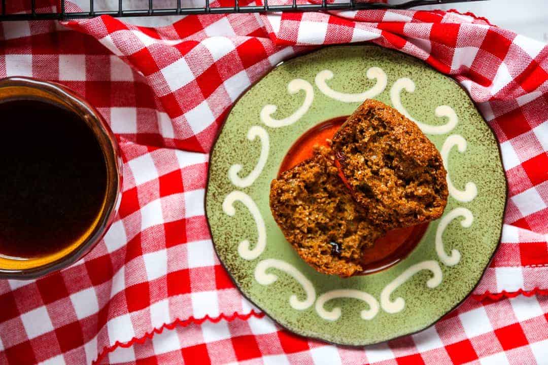 A muffin, cut in half, on a plate