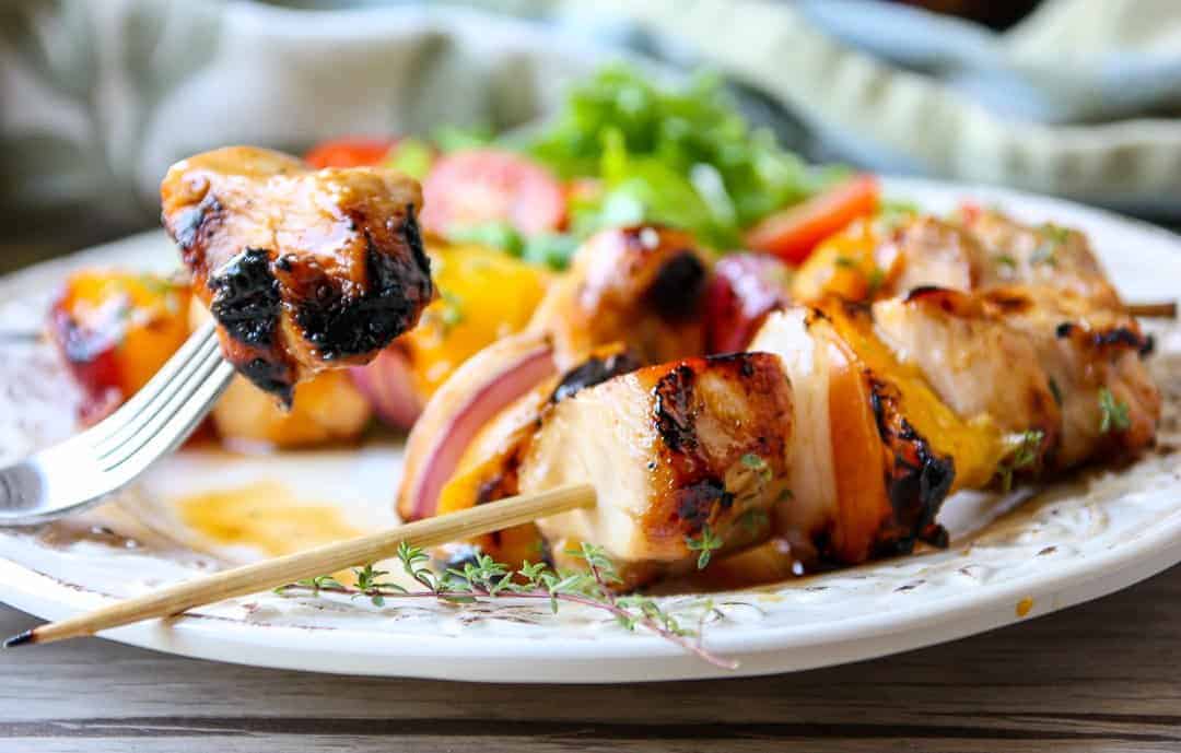 A close up of a plate of food, with Kebabs