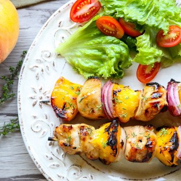 A plate of food, with Chicken and salad