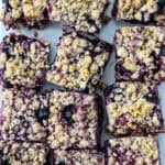 A batch of blueberry oatmeal bars on parchment paper.