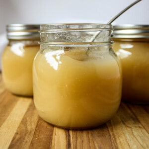Jars of homemade unsweetened applesauce.
