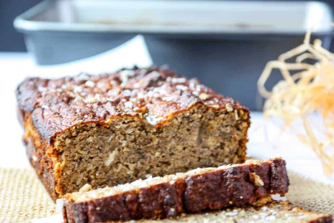A close up of a slice of banana loaf with coconut