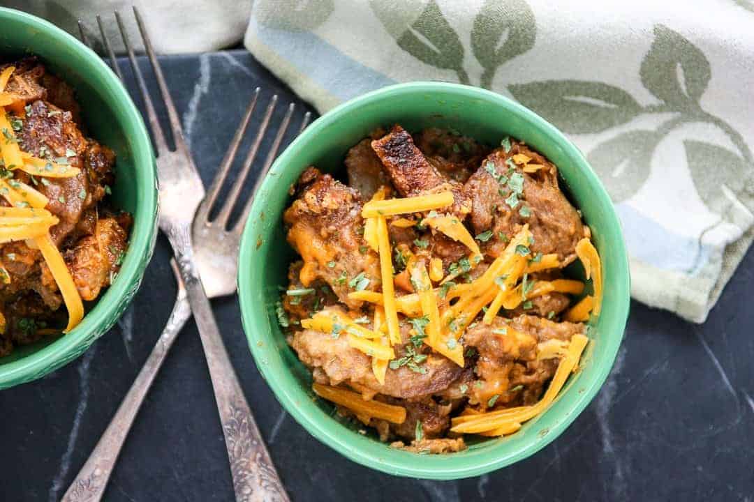 A bowl of bread pudding topped with cheese