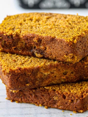 A stack of three slices of gluten free pumpkin loaf