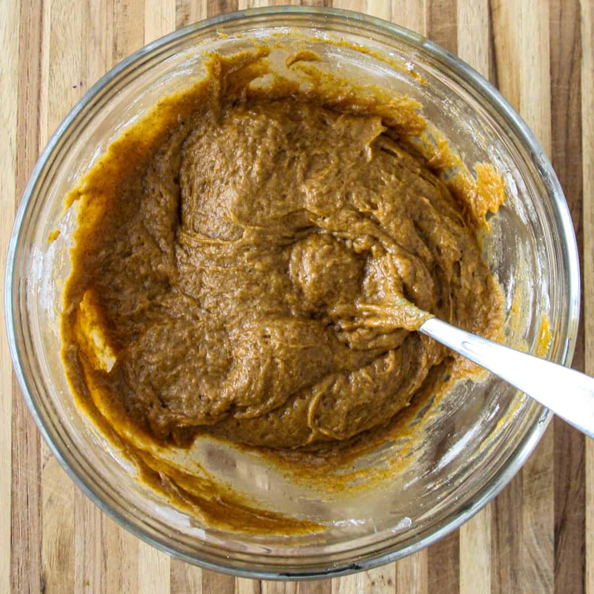 The finished batter for the pumpkin loaf in a glass bowl.