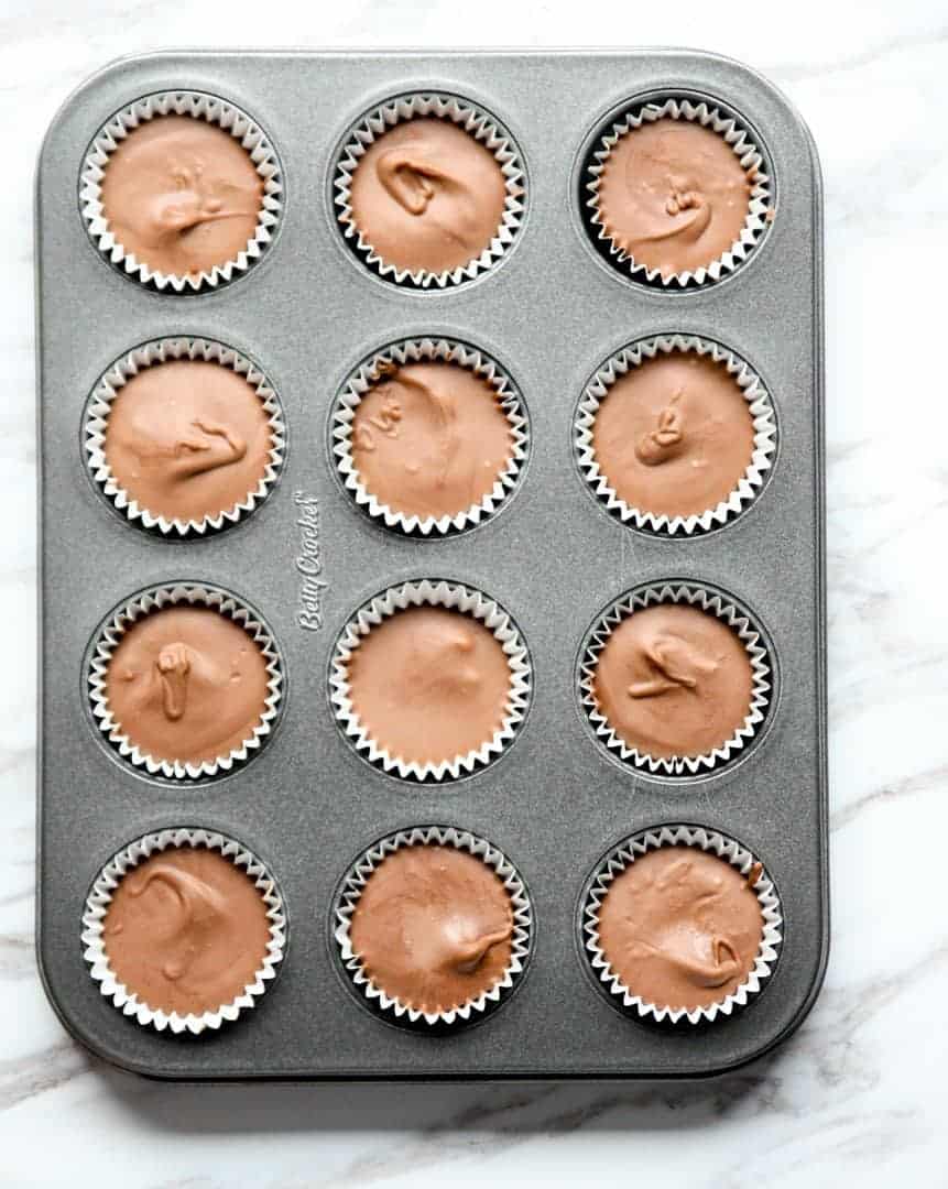 A mini muffin pan full of peanut butter cups