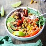 A bowl of food on a table, with a fork