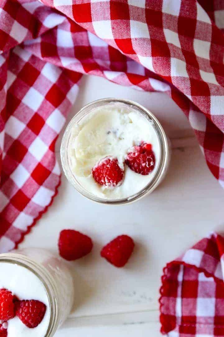 Mousse in a jar with berries on a table