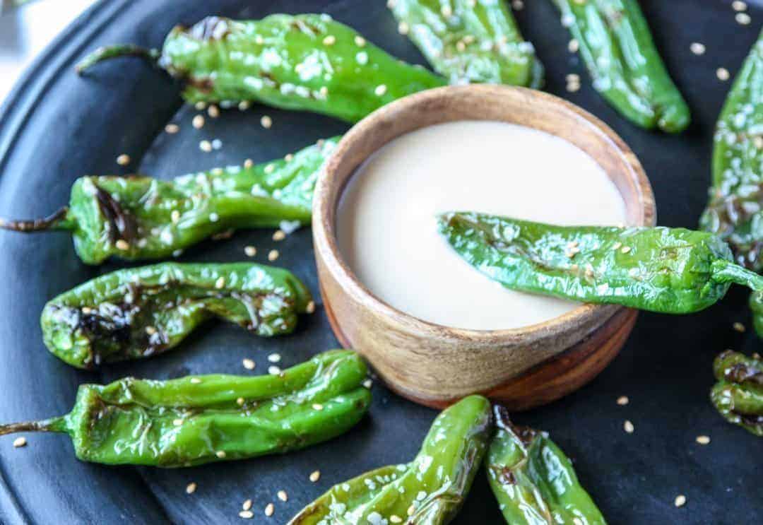 grilled peppers and dip on a plate