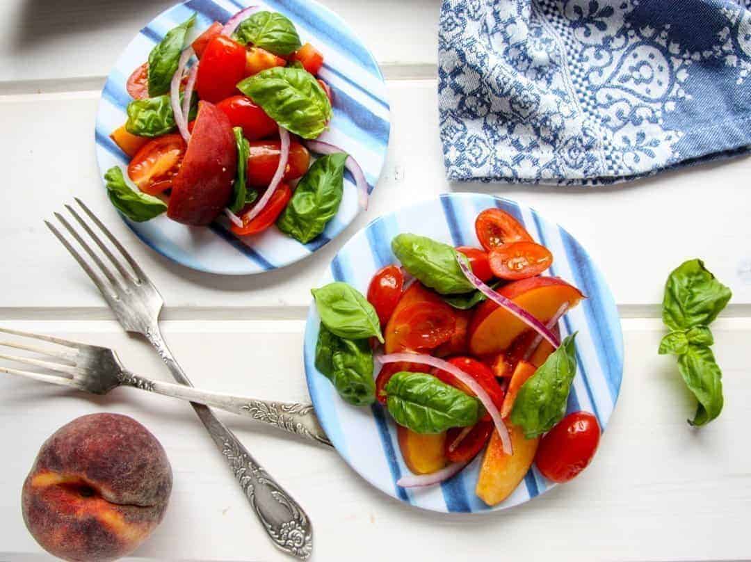 A plate of food on a table, with Peach and Tomato