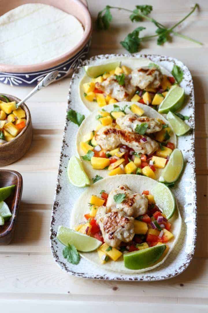 Three tacos on a plate on a table