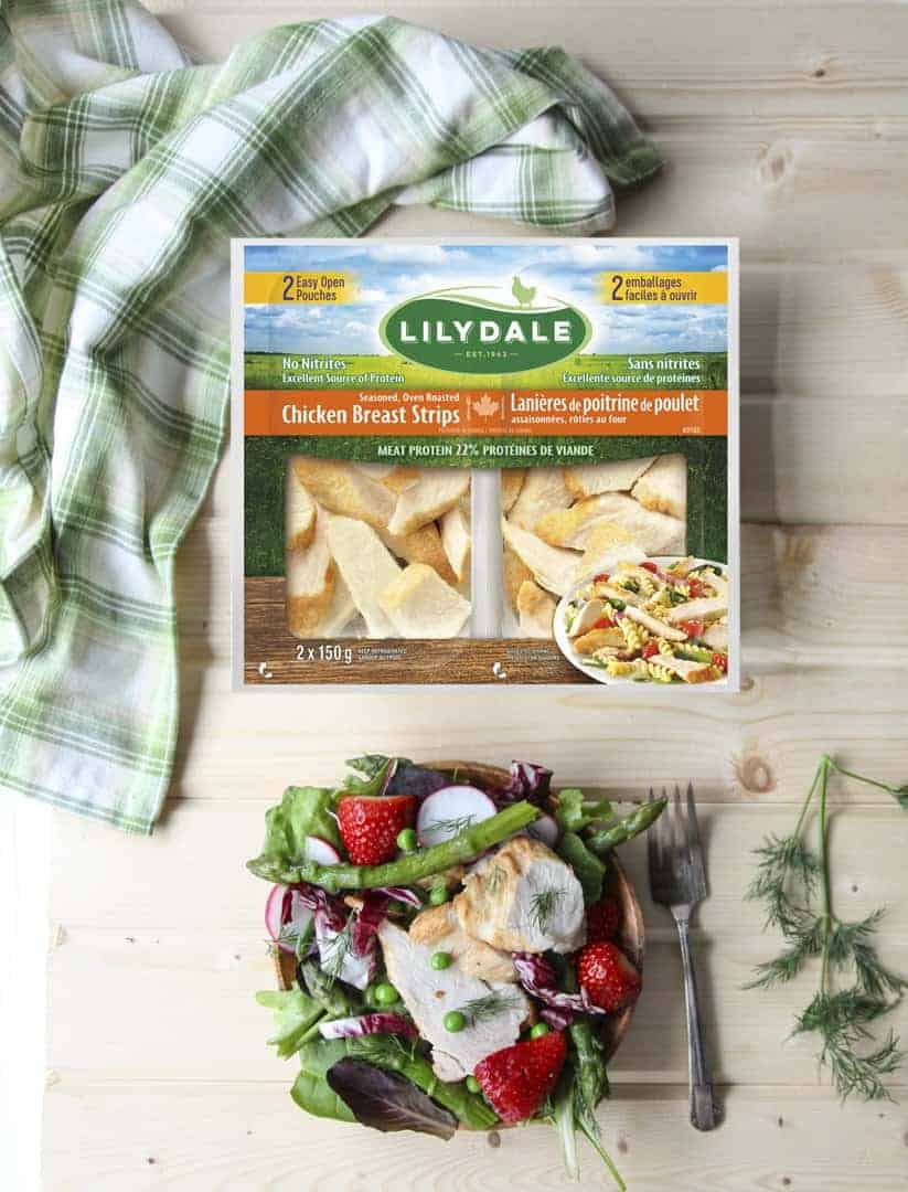 A package of cooked chicken on a cutting board