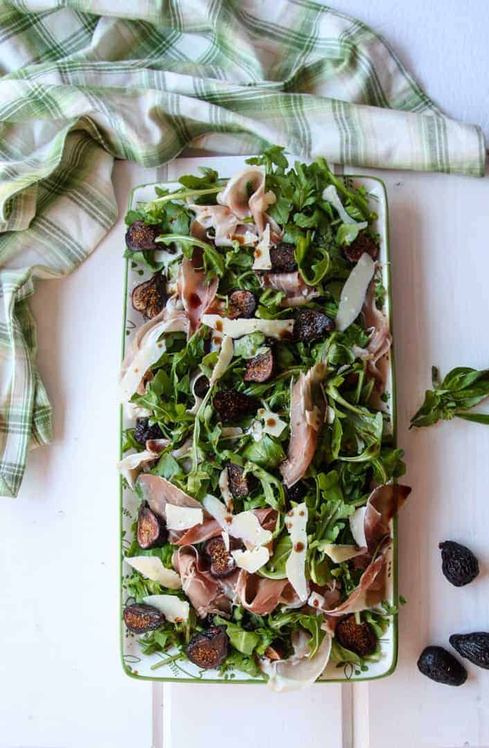 Salad of Arugula, Figs, Proscuitto, on a platter