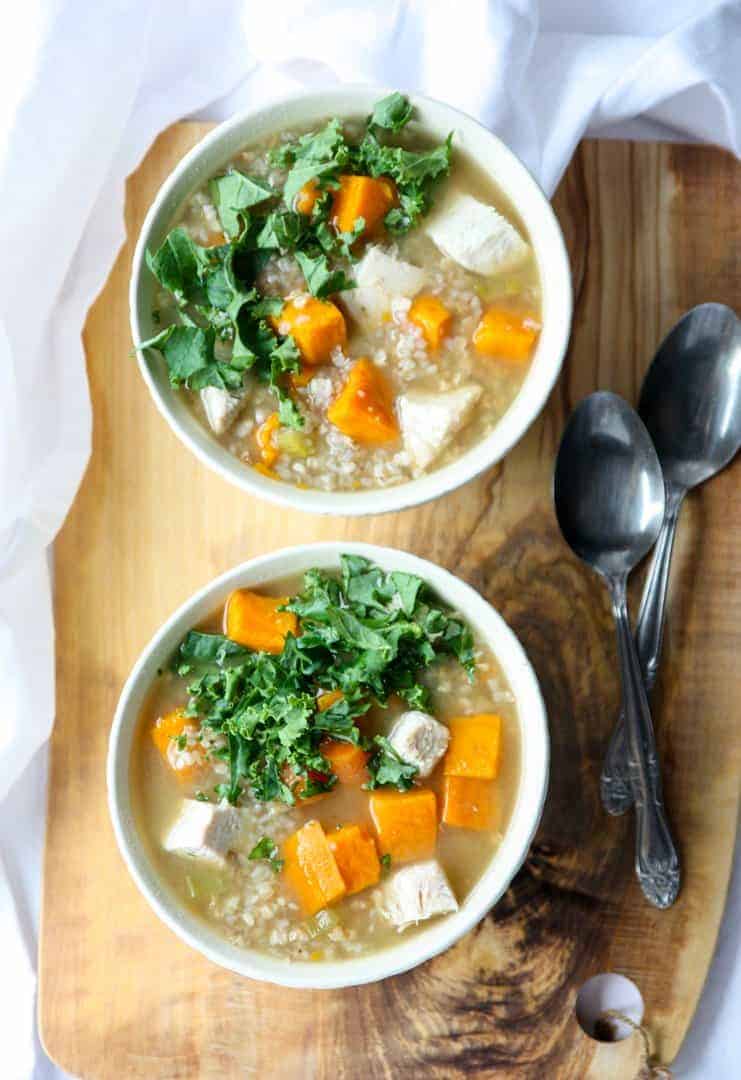 Two bowls of turkey buckwheat soup with kale and sweet potatoes