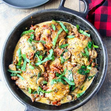 Marry me chicken (Sicilian Chicken) in a black cast iron pan.