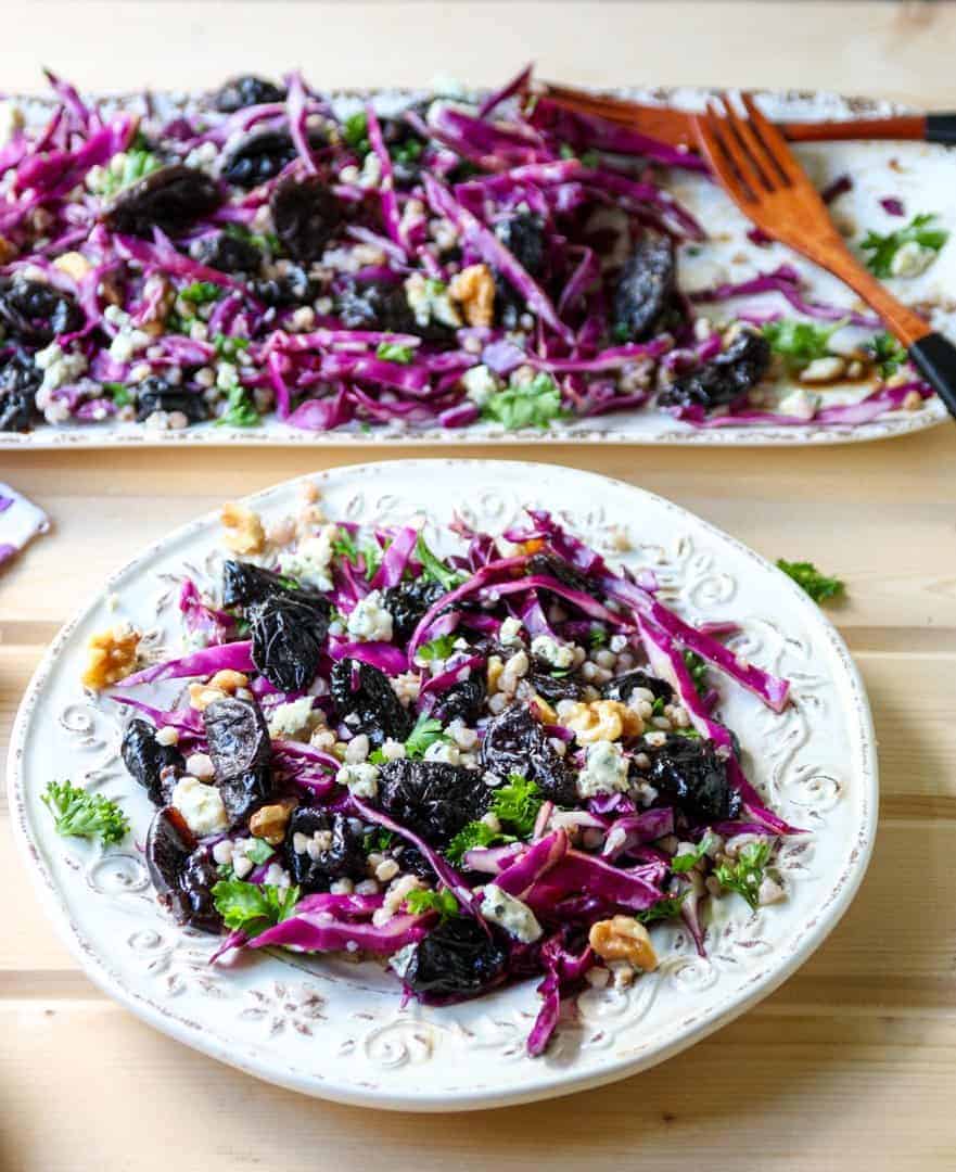 A plate of food on a table, with Salad and Red cabbage