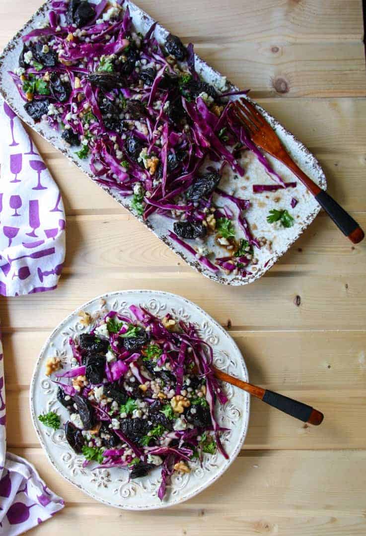 Platter of buckwheat salad with prunes and a serving of salad on a plate
