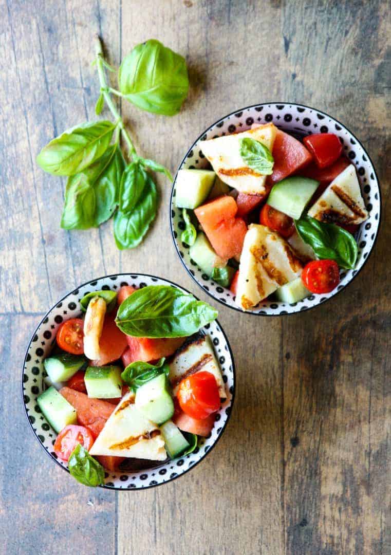 A bowl of fruit and vegetable salad, with Halloumi and Cheese