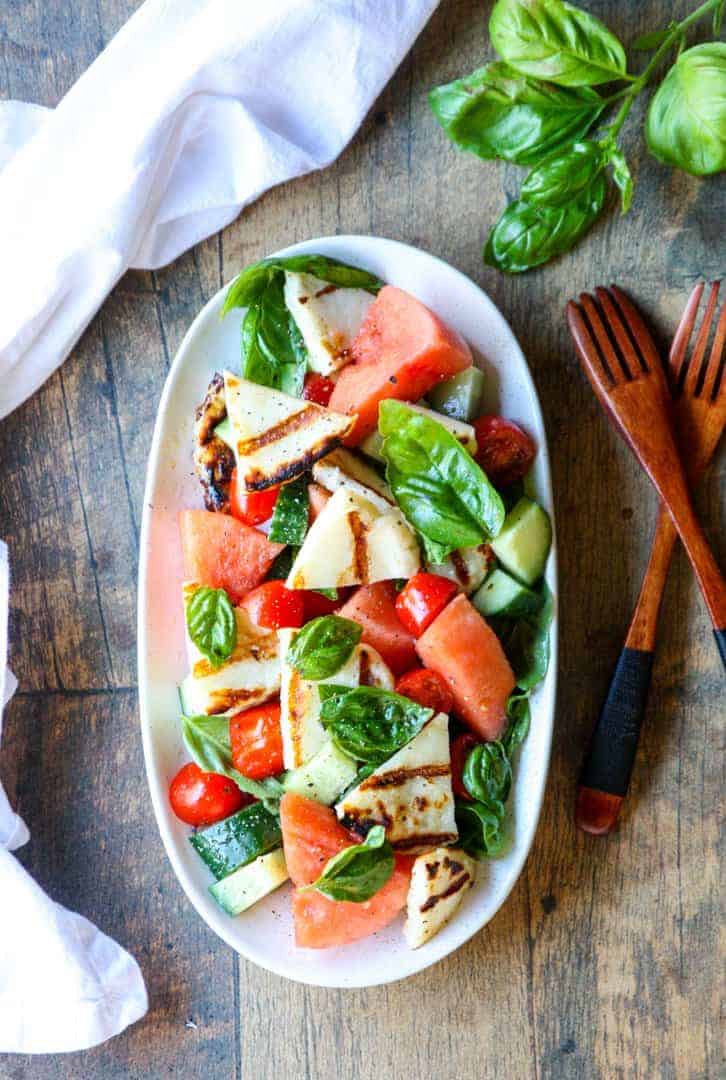 A plate of food on a table, with Halloumi and Salad