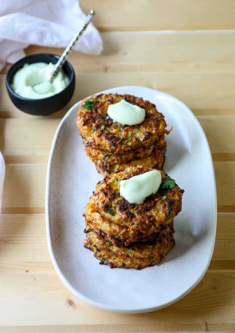 A plate of food on a table, with Fritter and Bread