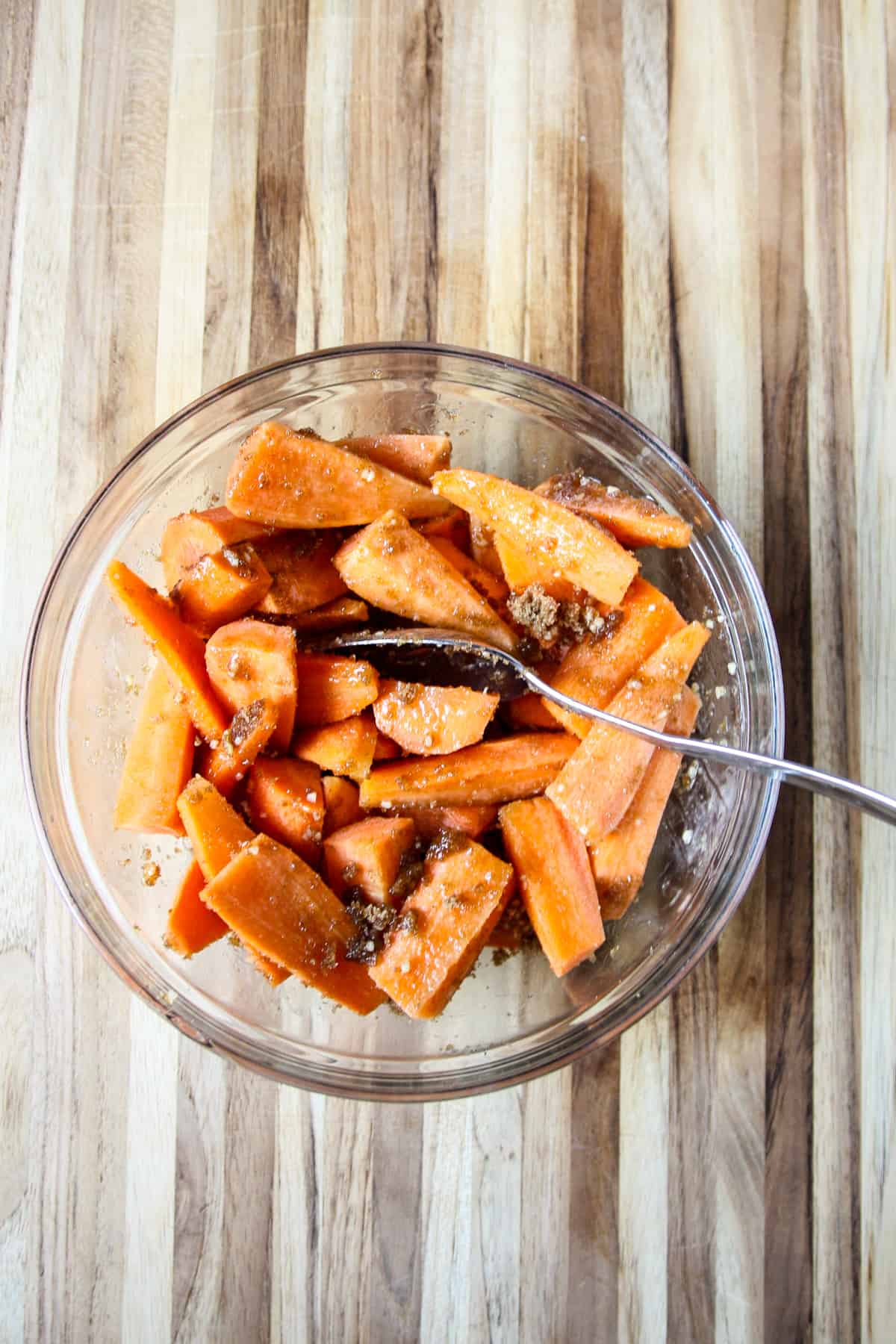 The ingredients being tossed together in a glass bowl.