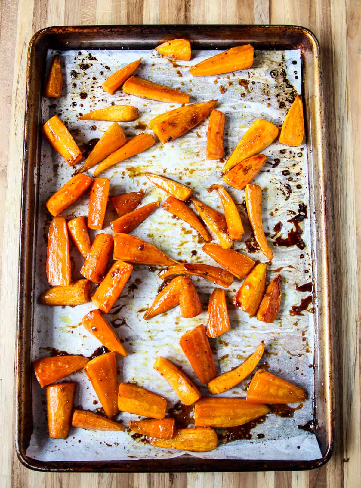 Roasted glazed carrots on a baking sheet fresh from the oven.