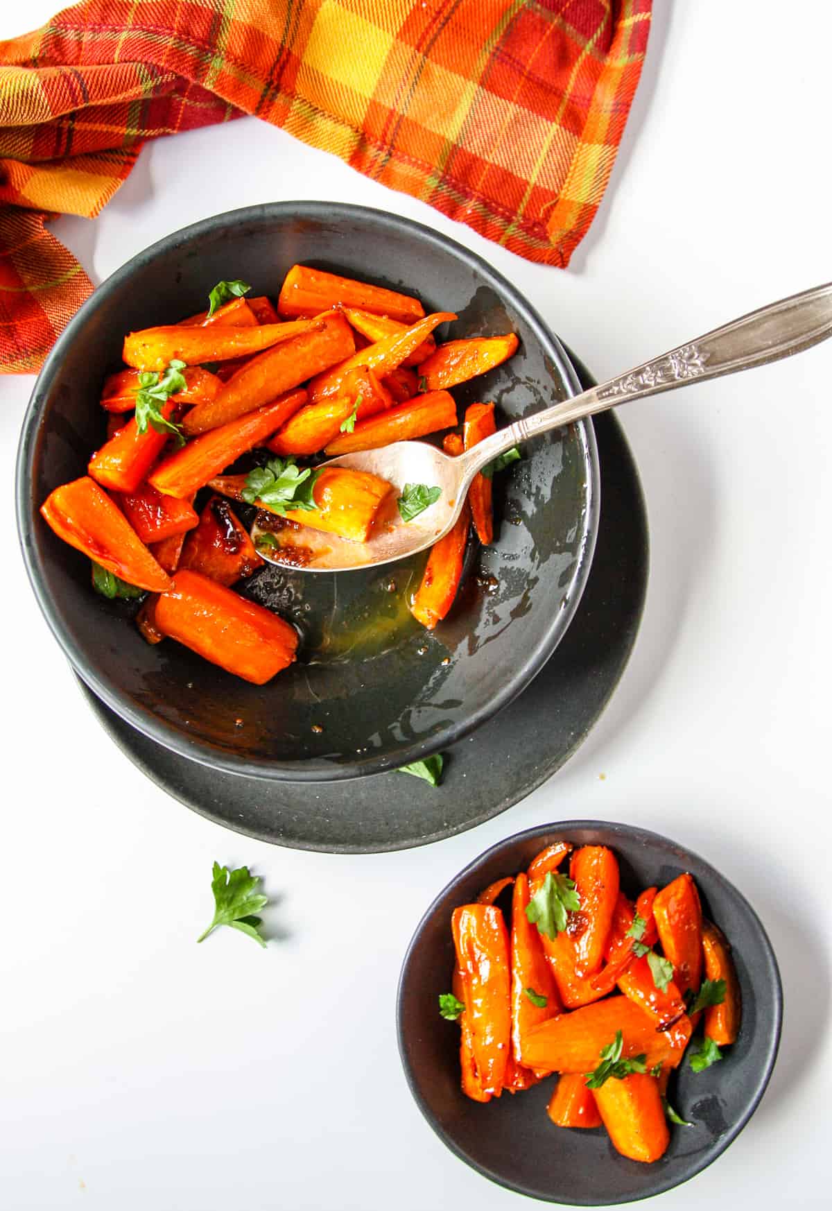 A dish of baked brown sugar carrots being served.