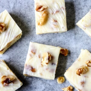 Maple walnut fudge pieces on parchment paper.