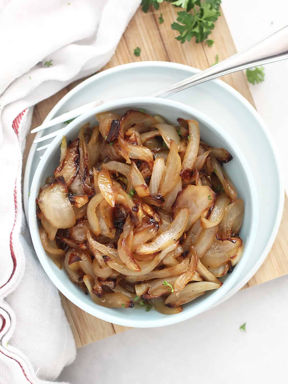Caramelized onions in a white bowl.
