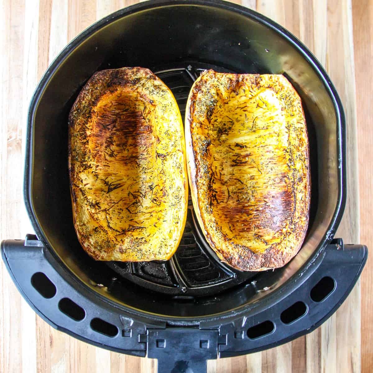 The cooked spaghetti squash in the air fryer basket.