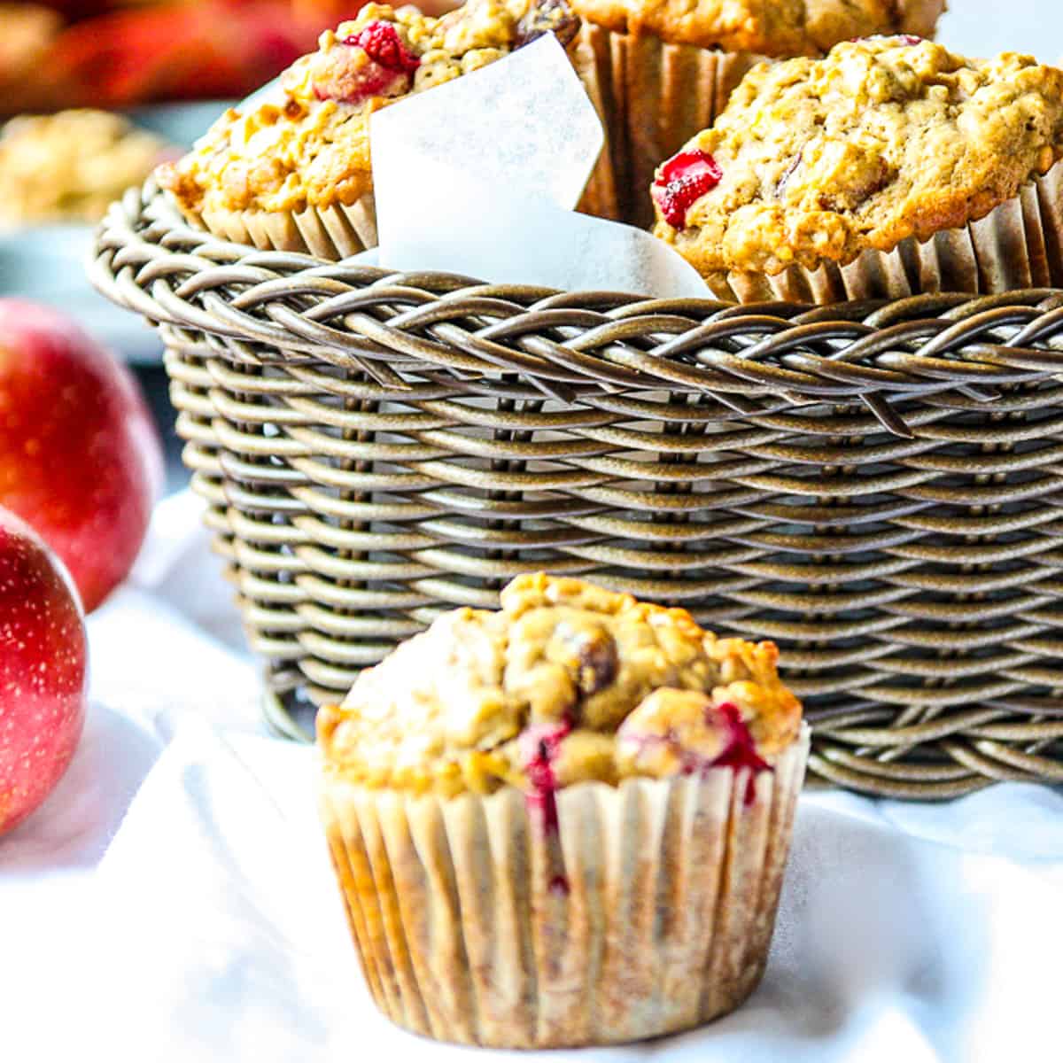 A freshly baked muffin beside a beside a basket.