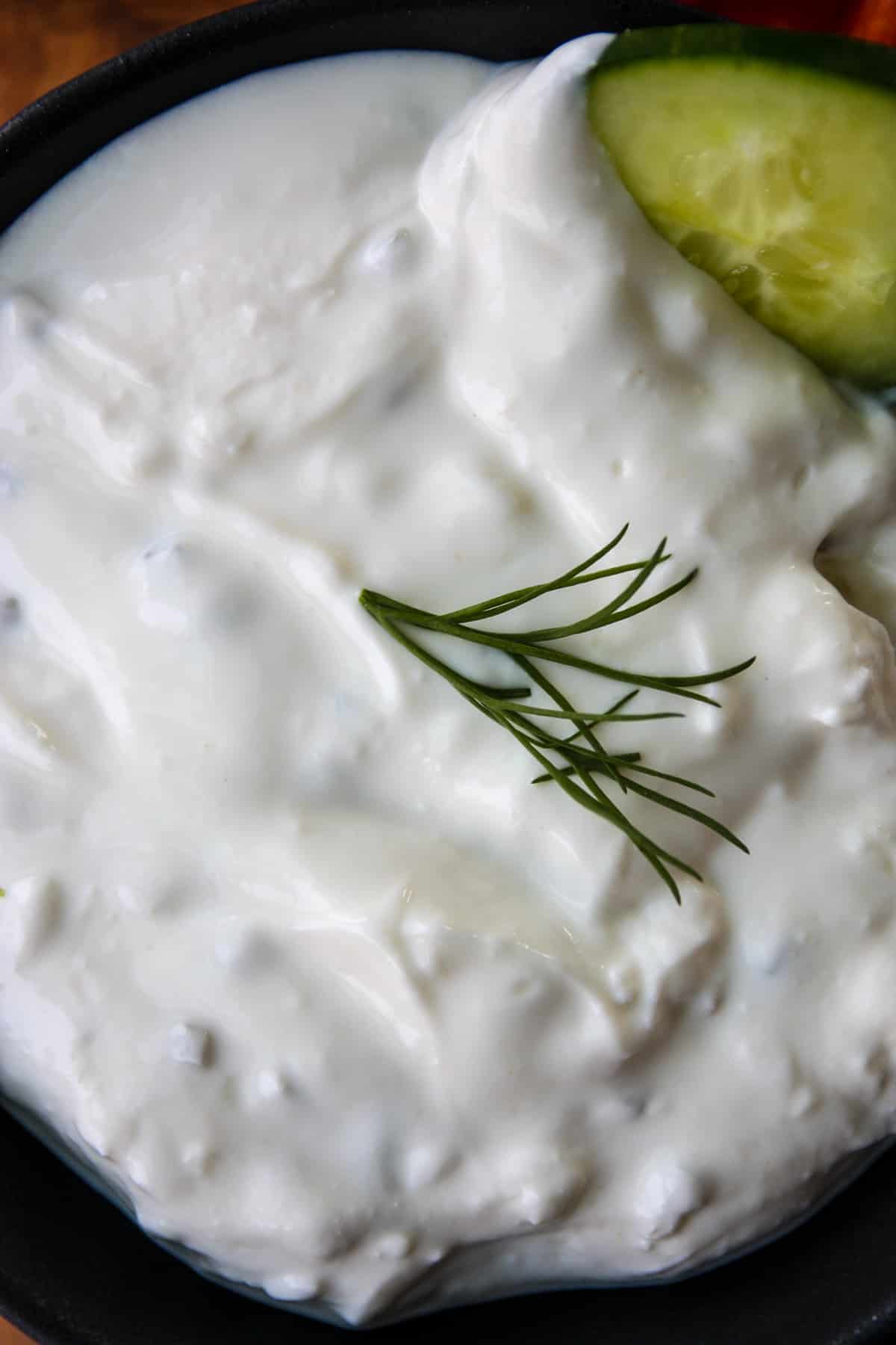 A close up of tzatziki sauce in a dish.
