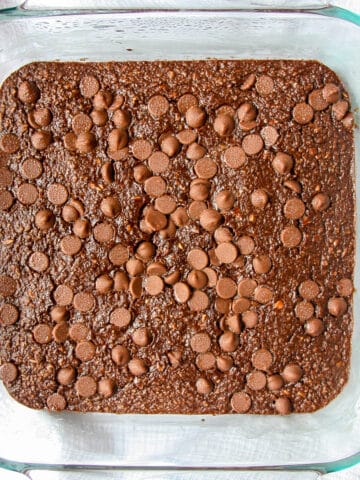 Chocolate baked oats in a square glass pan.