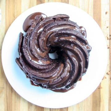 An air fryer chocolate bundt cake on a white plate.
