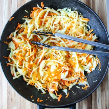 Stir fried cabbage in a cast iron wok.