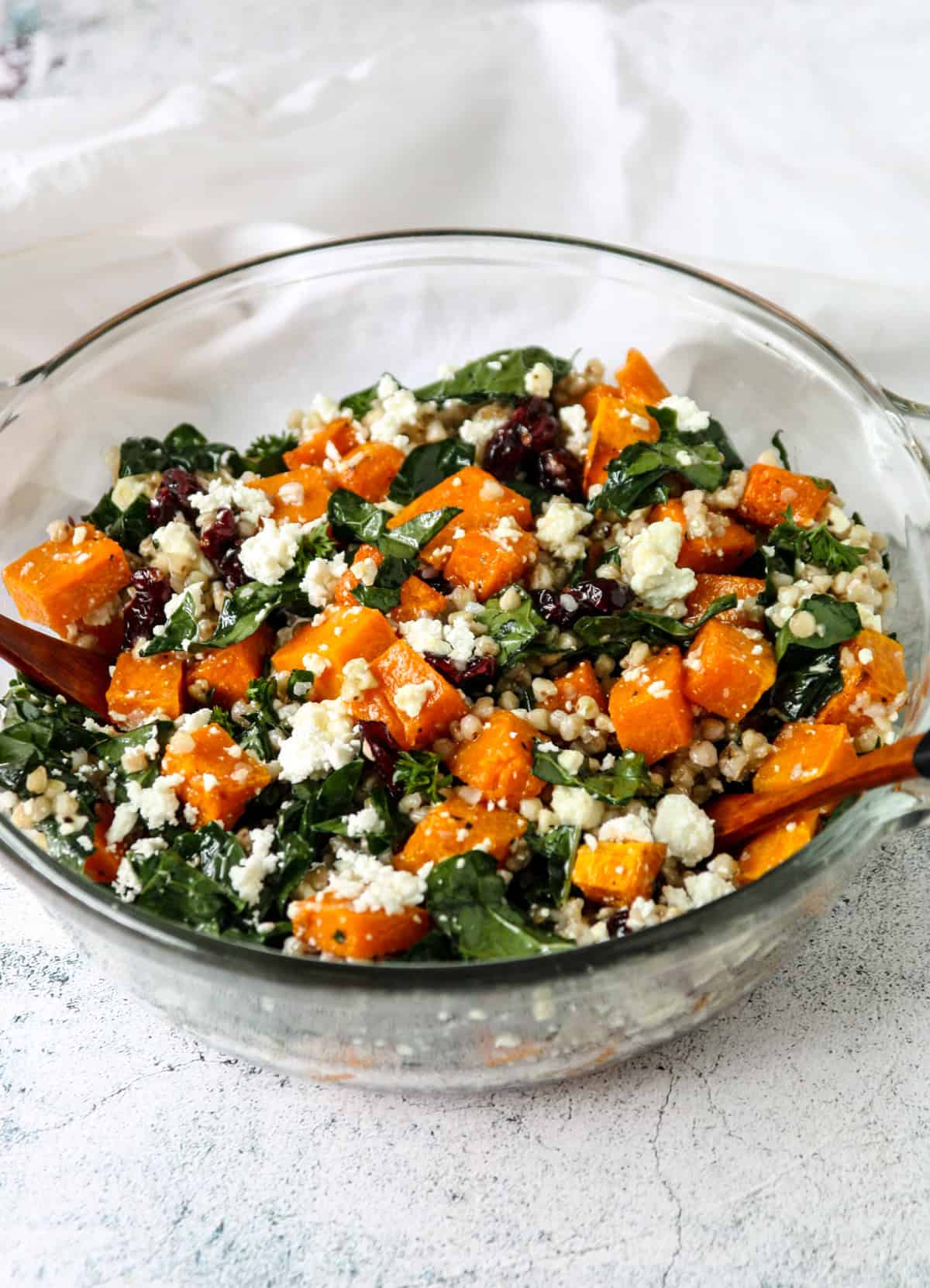 Butternut squash salad with feta and buckwheat in a glass bowl.