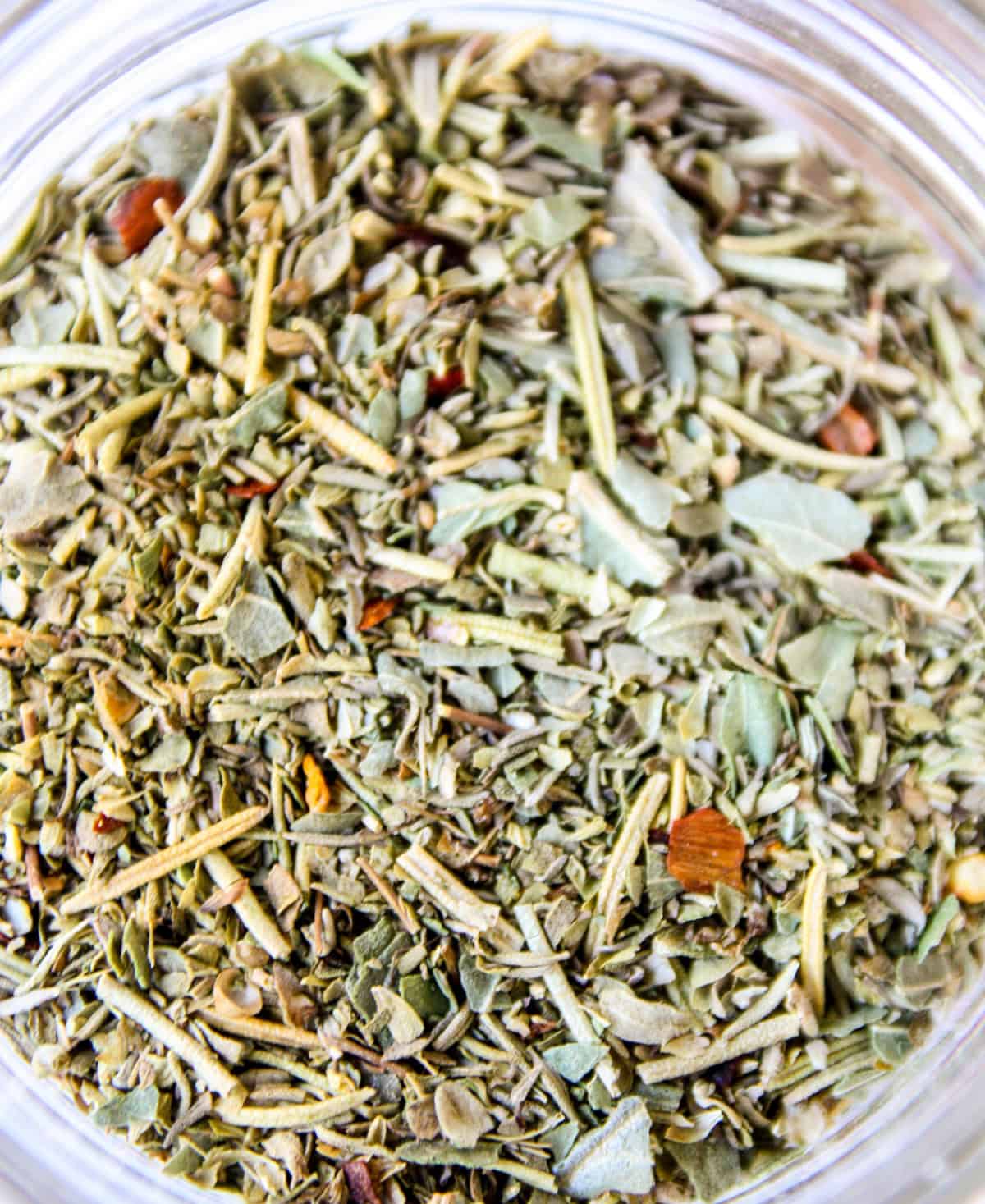 Homemade Italian seasoning in a glass jar.